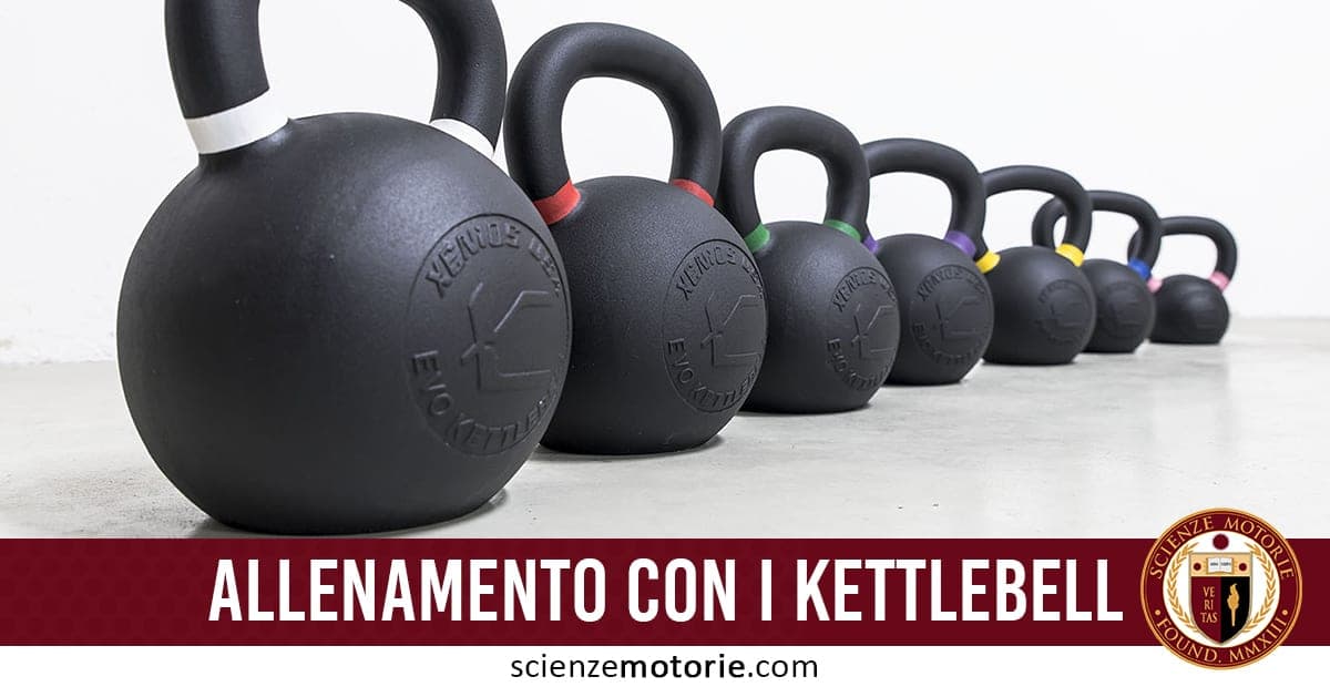 Fila di kettlebell disposti in ordine decrescente su pavimento con banner rosso "Allenamento con i kettlebell" e logo Scienze Motorie