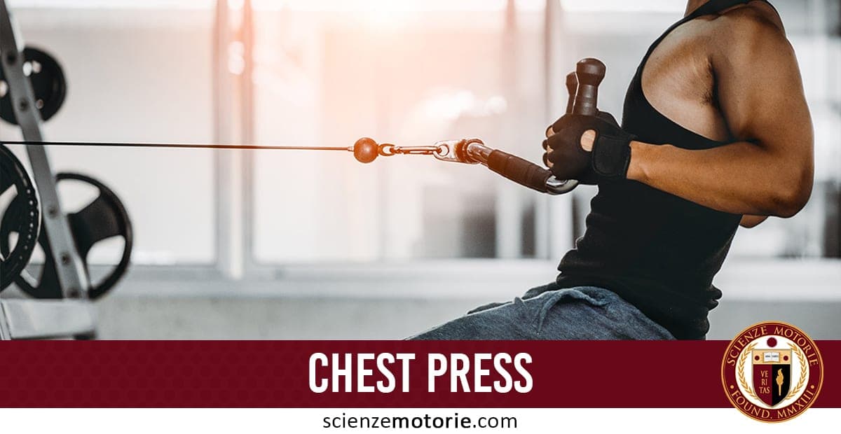 Persona che esegue esercizio di chest press con cavo in palestra, indossando canotta nera e guanti, con barra rossa "CHEST PRESS" e logo Scienze Motorie.