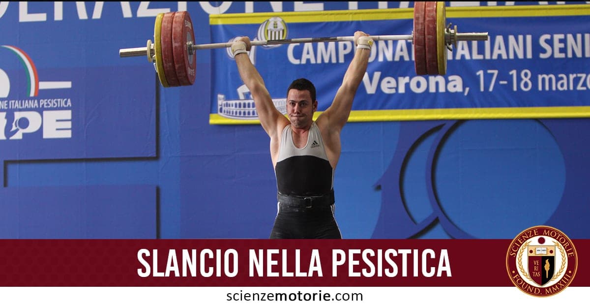 Atleta che esegue uno slancio sollevando un bilanciere sopra la testa durante una gara di pesistica a Verona.