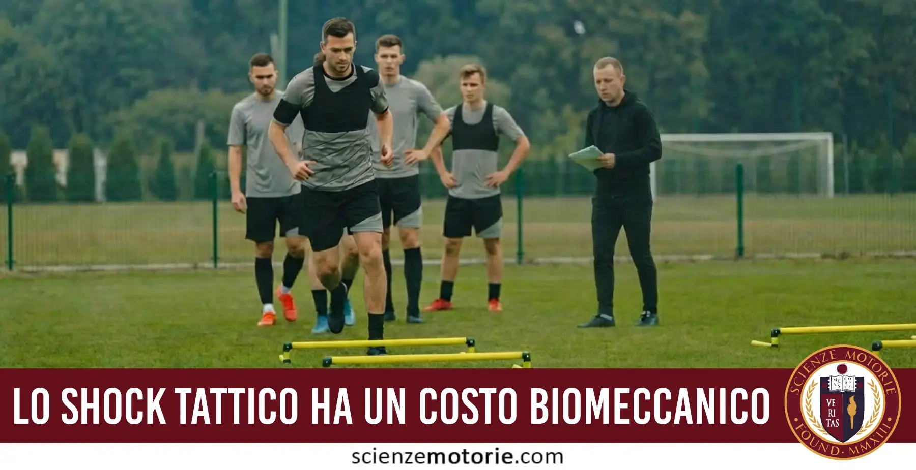 Atleta che corre su ostacoli bassi durante un allenamento con istruttore e compagni, con banner “Lo shock tattico ha un costo biomeccanico” e logo Scienze Motorie.